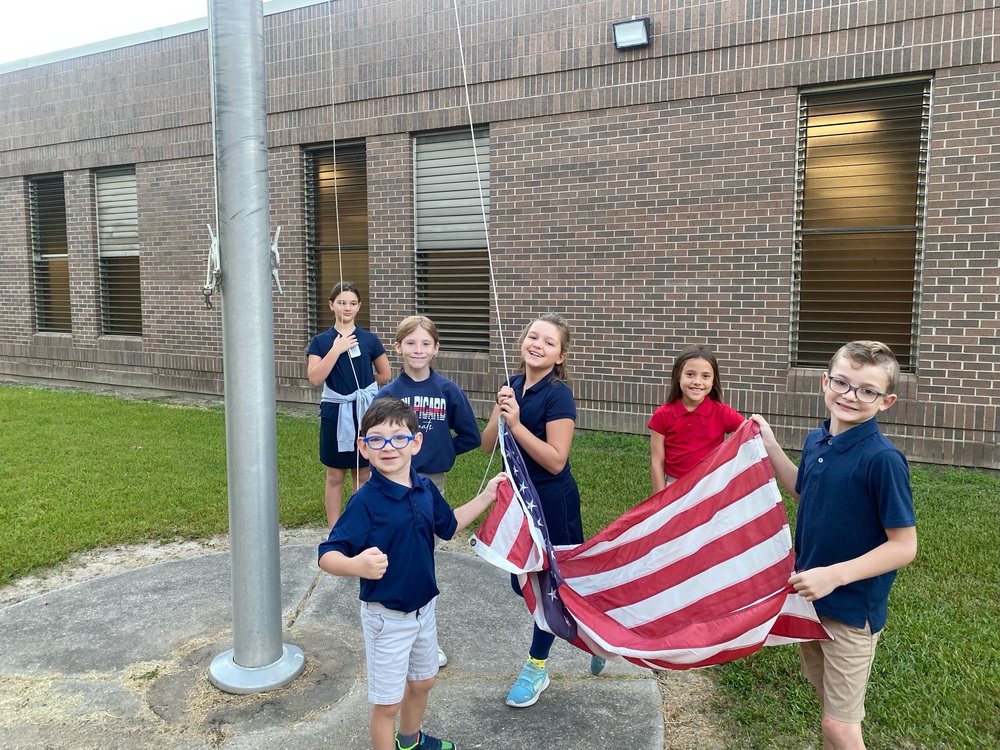 ​CPE  students raising the flag